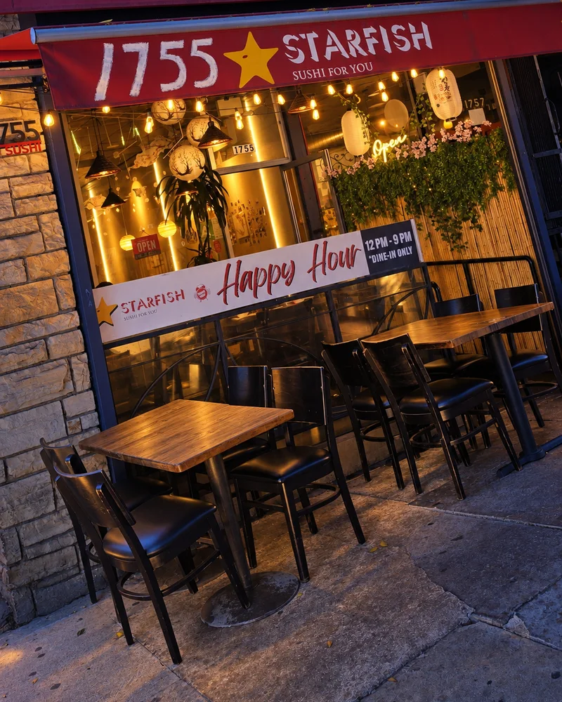 Patio tables under the red Starfish awning on Vermont Avenue at dusk